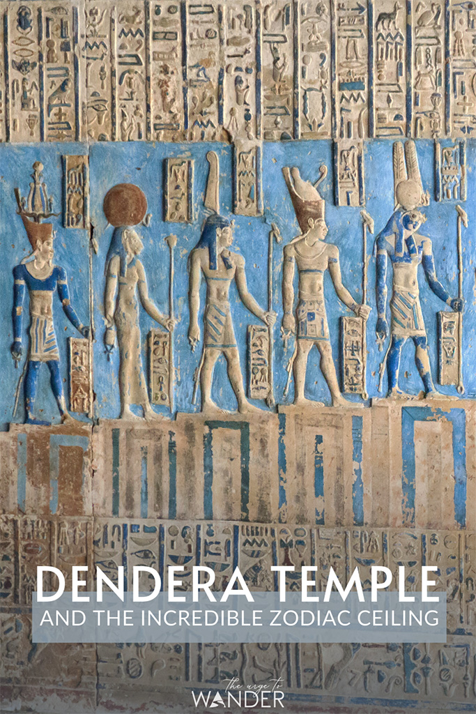 Close up of row of Egyptian deities in the turquoise ceiling of the temple of Hathor in Dendera.