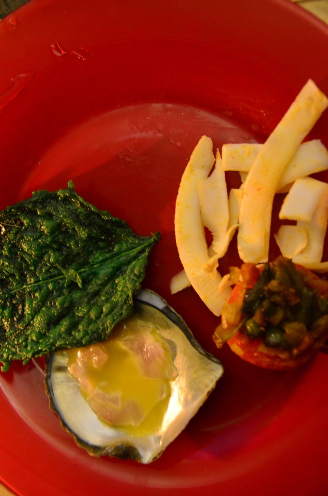 Red plate with food in Emerson Spice rooftop restaurant.