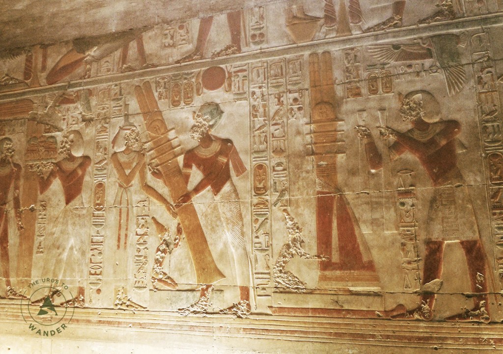 Painted relief showing the legend of the raising of the Djed where the Pharaoh is seen lifting a cross shaped wooden object with four cross bars at the top..