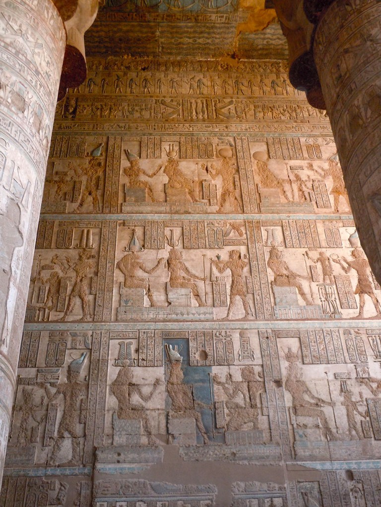Entire wall covered with square relief panels depicting pharaohs making offerings to gods