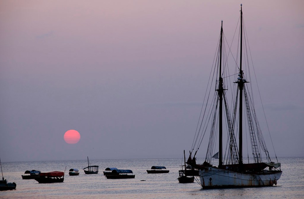 Zanzibar sunset - a lilac sky with a red orb - Stone Town Travel Guide