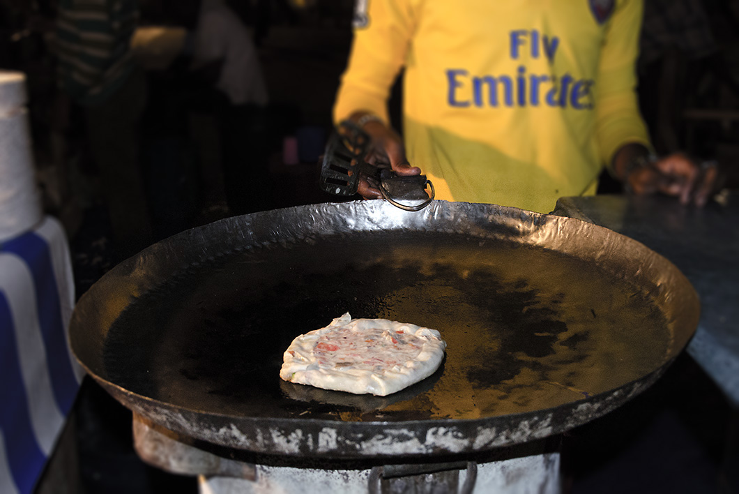 Zanzibar Pizza being fried on a skillet - Stone Town Travel Guide